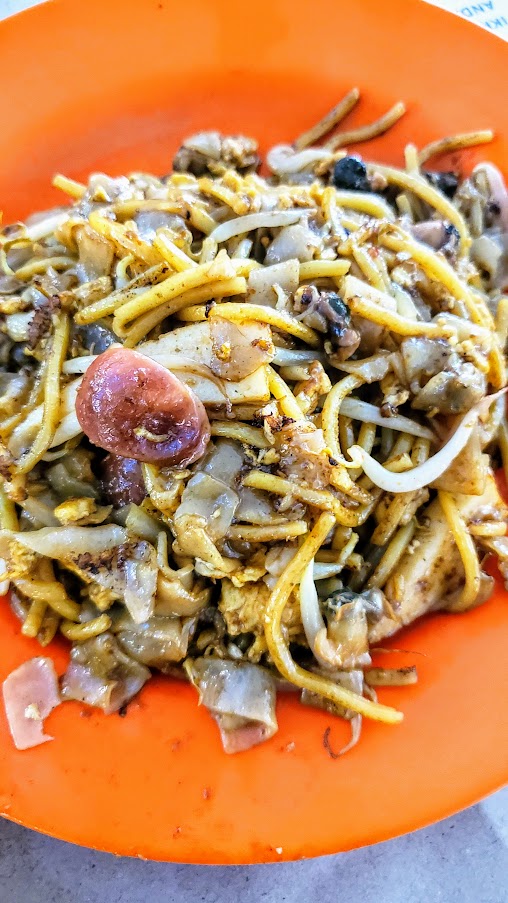 Guide to visiting Hawker Centers in Singapore - Tiong Bahru Char Kway Teow (Stall #02-11) to meet Mr. Tay Soo Nam, who started frying noodles at the age of 24 and although isn't doing the cooking now (he leaves it up to his daughter and husband) is still manning the hawker stall at 90 years old. The only dish to get here is the Char Kway Teow with chinese sausage, fishcake, cockles and beansprouts.