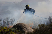 Cautionary notice was issued on Friday as wind fans smoke from Germiston landfill site fire File photo.