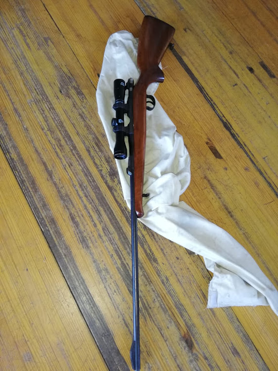 A .22 rifle with some rounds of ammunition were found inside one of the drug dens