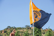 A fan holds a Kaizer Chiefs flag outside the club's headquarters at Naturena. File photo