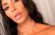 Kim Kardashian models A.Human's Human Glow SS19 necklace in an Instagram video.