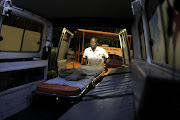 June 27, 2016. BETTER CONDITIONS:  Isaiah   Matidze , a paramedic at Masisi emergency medical services unit in Limpopo, loads an ambulance stretcher after cleaning the vehicle in a proper wahs bay. Photo Sandile Ndlovu. © Sowetan