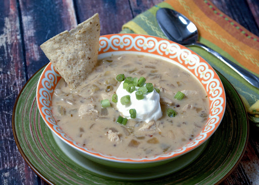 A bowl of creamy chicken, lime, and white bean chili.