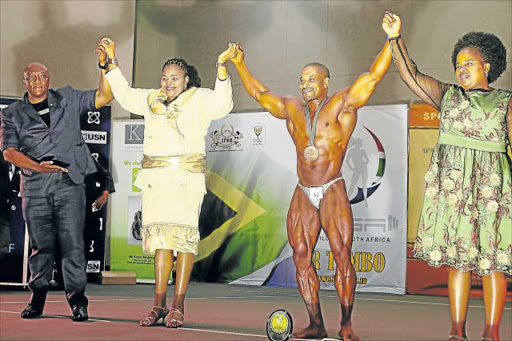 IN TOP SHAPE: Former Southern Africa bodybuilding championship winner Mike Adonis, flanked by Khaya Majeke, left, MEC Pemmy Majodina and OR Tambo district mayor Nomakhosazana Meth, will compete at Walter Sisulu University on Saturday at the OR Tambo Southern Africa Bodybuilding Championships Picture: ZINGISA MVUMVU