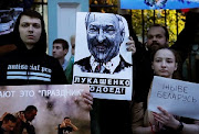 People take part in a protest against the results of Belarusian presidential election, outside the Belarusian embassy in Moscow, Russia August 12, 2020. 
