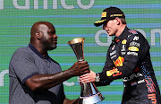 Race winner Max Verstappen of the Netherlands and Red Bull Racing celebrates on the podium with NBA legend Shaquille O'Neal during the Formula One Grand Prix of USA at Circuit of The Americas on October 24, 2021 in Austin, Texas. 