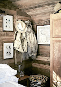 The bedroom is filled with campaign-style pieces and decor touches, such as ornithological drawings and maps. 