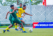 Bafana Bafana's Themba Zwane and Percy Tau (obscured) challenge Claude Niyomugabo of Rwanda in the 2026 Fifa World Cup qualifier at Stade Huye in Butare, Rwanda on Tuesday.