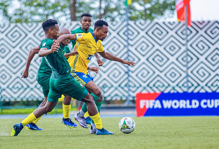 Bafana Bafana's Themba Zwane and Percy Tau (obscured) challenge Claude Niyomugabo of Rwanda in the 2026 Fifa World Cup qualifier at Stade Huye in Butare, Rwanda on Tuesday.