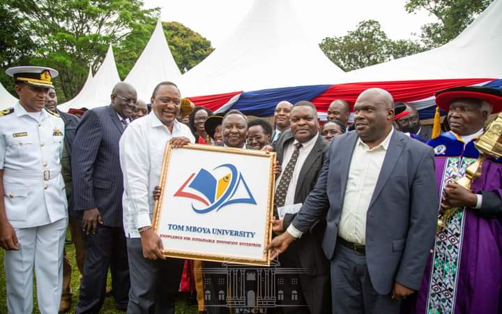 President Uhuru Kenyatta with university council members displays the charter he awarded Tom Mboya University College at Kakamega State Logde on August 2, 2022