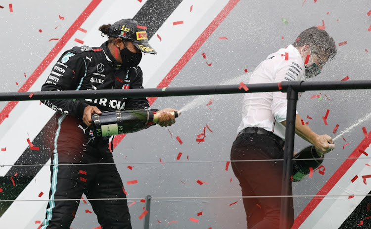 Mercedes' Lewis Hamilton celebrates on the podium with Mercedes race engineer Peter Bonnington after the Portuguese Grand Prix at Algarve International Circuit, Portimao on October 25, 2020