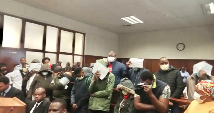 Senior ANCYL leader in Musa Dladla region, Sanele Masuku (red shirt and jacket), is among 20 people who appeared in the Durban magistrate's court on Friday.