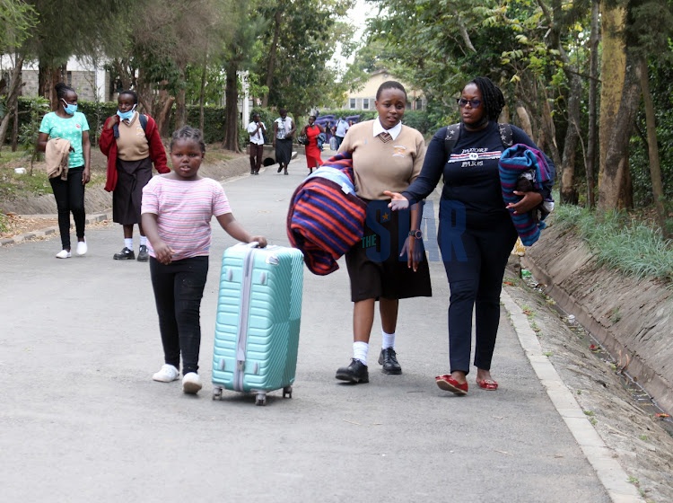 Students at Buruburu Girls High School carrying their belongings on November 1, 2021