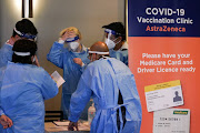 Medical staff work in the waiting area at a coronavirus disease (Covid-19) vaccination clinic at the Bankstown Sports Club as the city experiences an extended lockdown, in Sydney, Australia, August 3, 2021.  