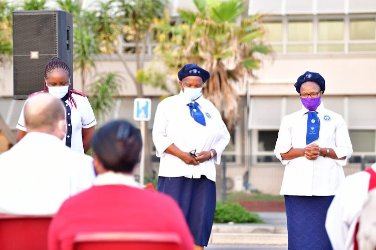 Nurses in prayer at the beachfront Good Friday service.