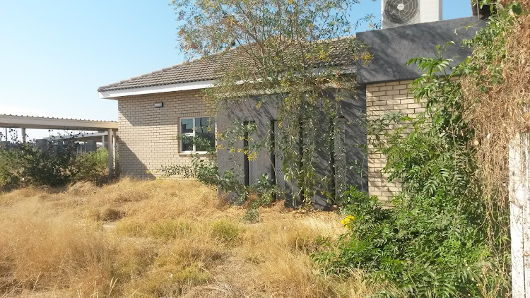 Weeds are growing around the new police station at Moeka village.