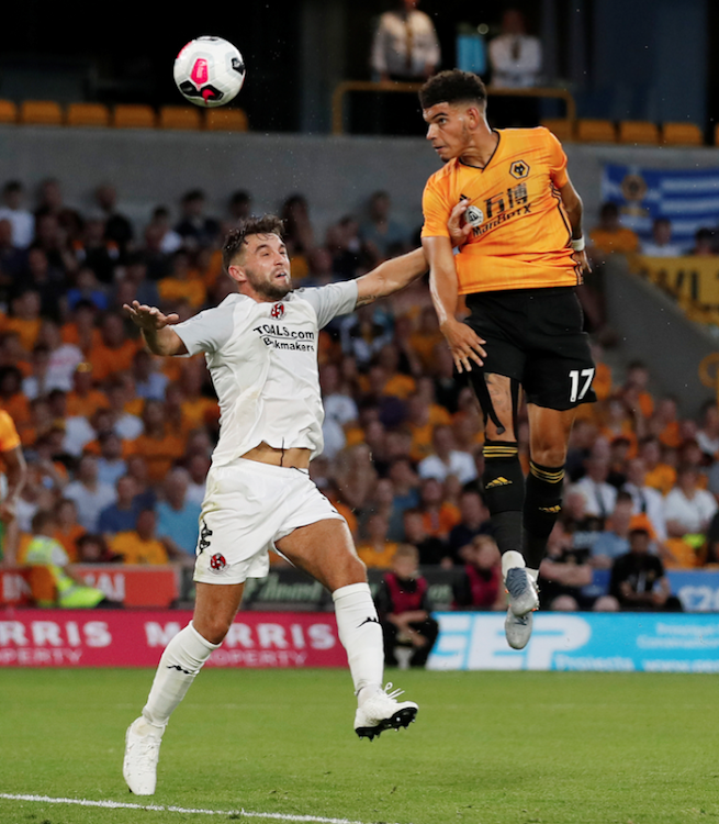 Wolverhampton Wanderers' Morgan Gibbs-White in action with Crusaders' Christopher Hegarty