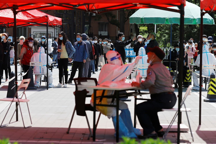 People line up at a makeshift Covid-19 testing site during a mass testing in Beijing, China, May 2 2022. Picture: CARLOS GARCIA RAWLINS/REUTERS