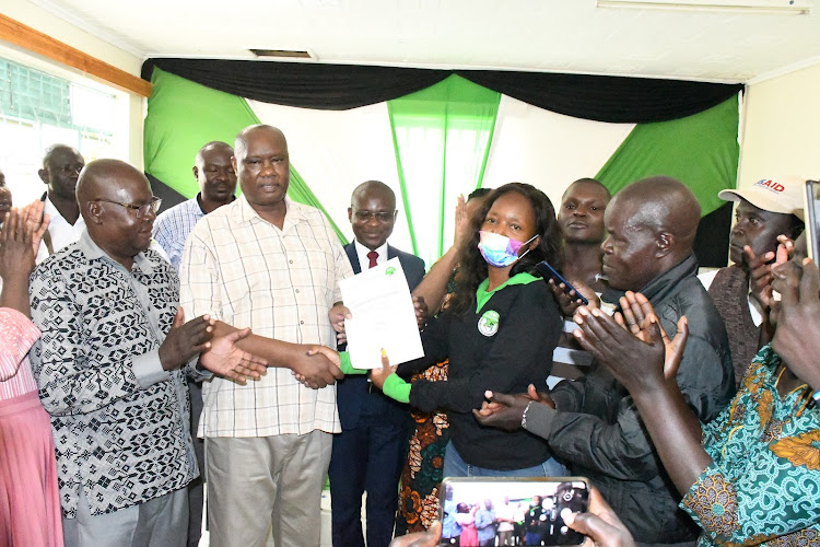 Governor Ojaamong receives his clearance certificate from Teso South IEBC chief Carol Okki on May 30.