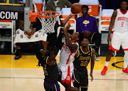 Houston Rockets guard Armoni Brooks (7) moves to the basket against Los Angeles Lakers center Montrezl Harrell (15) during the second half at Staples Center.