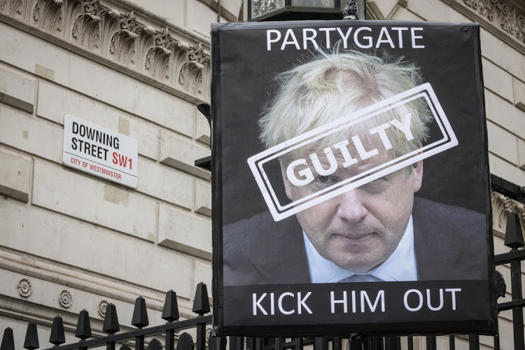 A protest sign is seen outside Downing Street on April 13, 2022 in London, England. The Prime Minister Boris Johnson and Chancellor of the Exchequer Rishi Sunak have both been issues with Fixed Penalty Notices by the Metropolitan Police in relation to parties that took place in 10 Downing Street.