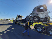 Two trucks are transported off from the N1 outside Stellenbosch after they were set alight and used to prevent motorists from using the highway.