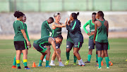 Banyana Banyana players share a light moment during training at their base at Ndoum Stadium in Ghana on November 19 2018. 
