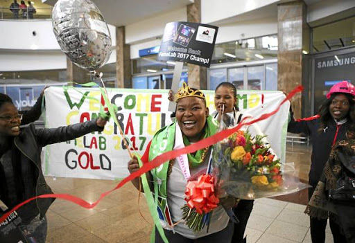 GOLD STAR: Geologist Tshiamo Legoale is welcomed back by friends, family and colleagues at OR Tambo International Airport after winning an international science competition.