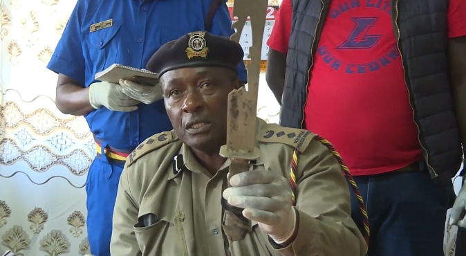 Nakuru Town West OCPD Samson Gathuku displays a panga confiscated from Confirm members after a police crackdown in early June.