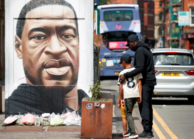 A mural of George Floyd in Manchester, England. The white officer stopped kneeling on the suspect after he cried out "Get off my neck".