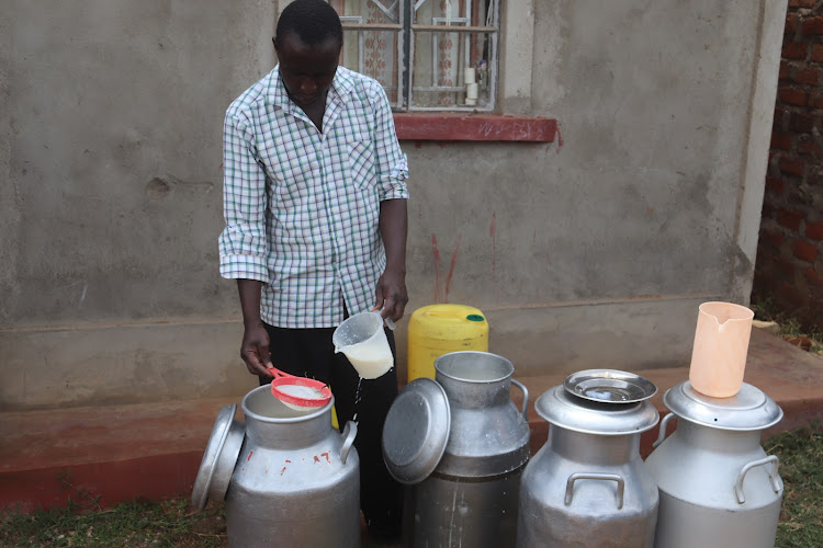 Kennedy Wakoli prepares milk ready for boiling.