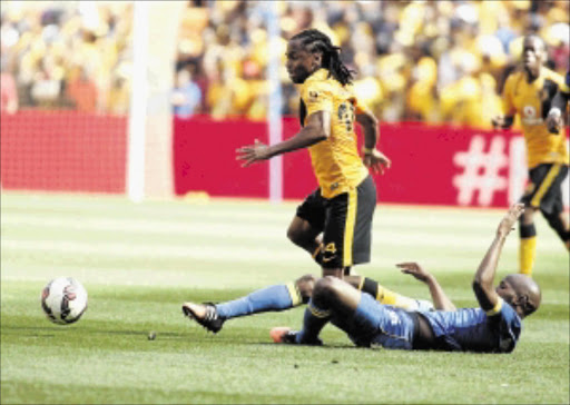 In full flight: Kaizer Chiefs midfieder Siphiwe Tshabalala dribbles past Mamelodi Sundowns defender Ramahlwe Mphahlele during their 1-1 drawn Absa Premiership match at FNB Stadium on Saturday PHOTO: ANTONIO MUCHAVE