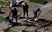 A cemetery worker uses a cross to even out the soil at the Flores cemetery, amid the outbreak of the coronavirus disease (Covid-19) in Buenos Aires, Argentina April 21, 2021.