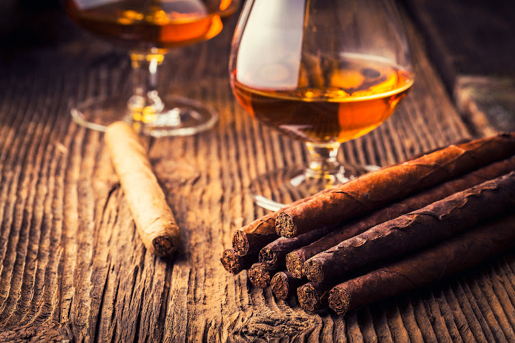 Quality cigars and cognac on an old wooden table