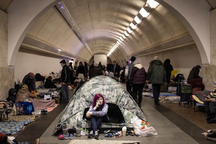 A woman sits in a tent as people take shelter in the Dorohozhychi subway station that has been turned into a bomb shelter in Kyiv, Ukraine. Picture: GETTY IMAGES/CHRIS MCGRATHE