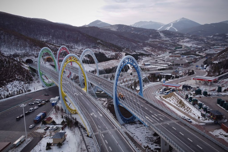 Five Olympic rings arch over a highway leading to venues for the Winter Olympics Beijing 2022 in Zhangjiakou, Hebei province, China