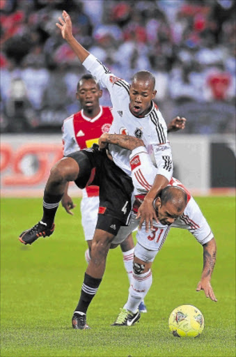 TUSSLE: Happy Jele of Orlando Pirates and Lance Davids of Ajax Cape Town in action during their Premiership match at Cape Town Stadium last night.Photo: Gallo Images/Getty Images