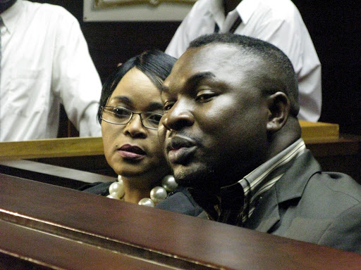 Sheryl Cwele, the wife of South African Minister of State Security, Siyabonga Cwele, and co-accused Frank Nabolisa sit in court on trial for trafficking cocaine, dealing drugs, and recruiting drug mules, on October 13, 2010 in Pietermaritzburg, South Africa.