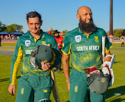 Quinton de Kock and Hashim Amla of South Africa after their record breaking innings during the 1st Momentum ODI match between South Africa and Bangladesh at Diamond Oval on October 15, 2017 in Kimberley, South Africa.