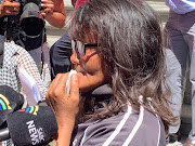 Courtney Pieters' mother, Juanita Pieters, weeps outside the high court in Cape Town on Tuesday December 11, 2018, after her daughter's killer, Mortimer Saunders, was given two life sentences.