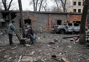 Local residents are seen near a residential building destroyed by a Russian missile strike, amid Russia’s attack on Ukraine, in Kramatorsk, Ukraine February 2, 2023. 