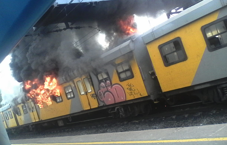 Flames leap from a train at Retreat station, Cape Town, on Thursday.