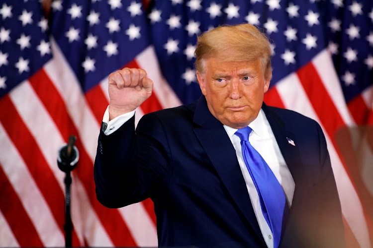 US President Donald Trump raises his fist as he reacts to early results from the 2020 US presidential election in the East Room of the White House in Washington, US on November 4 2020.