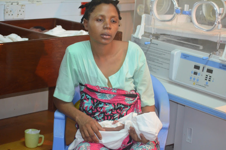 Mishi Kitsao holds one of her quadruplets at the Kilifi county hospital HDU on Friday 17th April