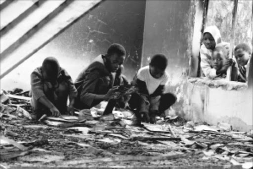 220100218 BMA Kids at play. They were captutred playing inside the burned down public library in Siyathemba township, Balfour, Mpumalanga. There is planned stay-away and residents waited for the minister at impatiently. Pic: BAFANA MAHLANGU. 18.02/2010. © sowetan