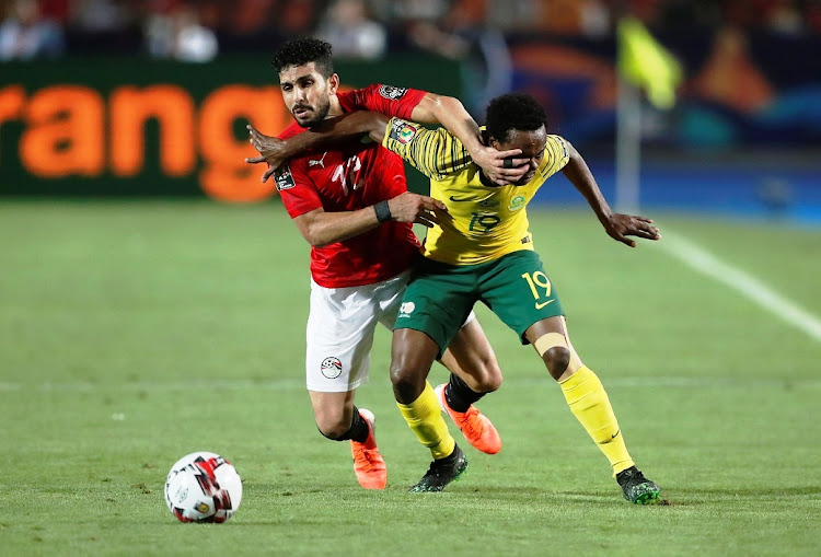 Egypt's Ayman Ashraf battles with South Africa's Percy Tau.