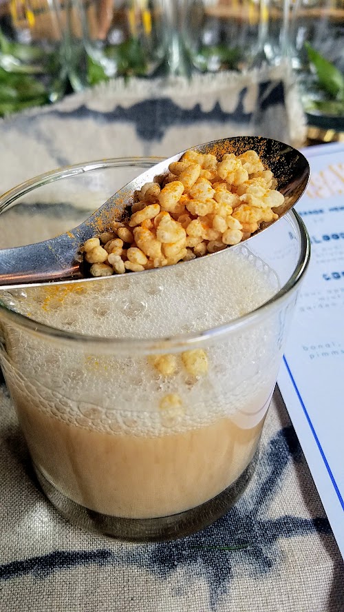 Aramsey Spiced Brunch with Ruchikala and Public Provisions: Crunchy Chai cocktail, with housemade chai with lillet, aged rum, crispies, peanut oil, turmeric, cardamon, and chamomile coconut foam. The spoon of crispies is meant to be dipped into the cocktail, as a nod to cereal