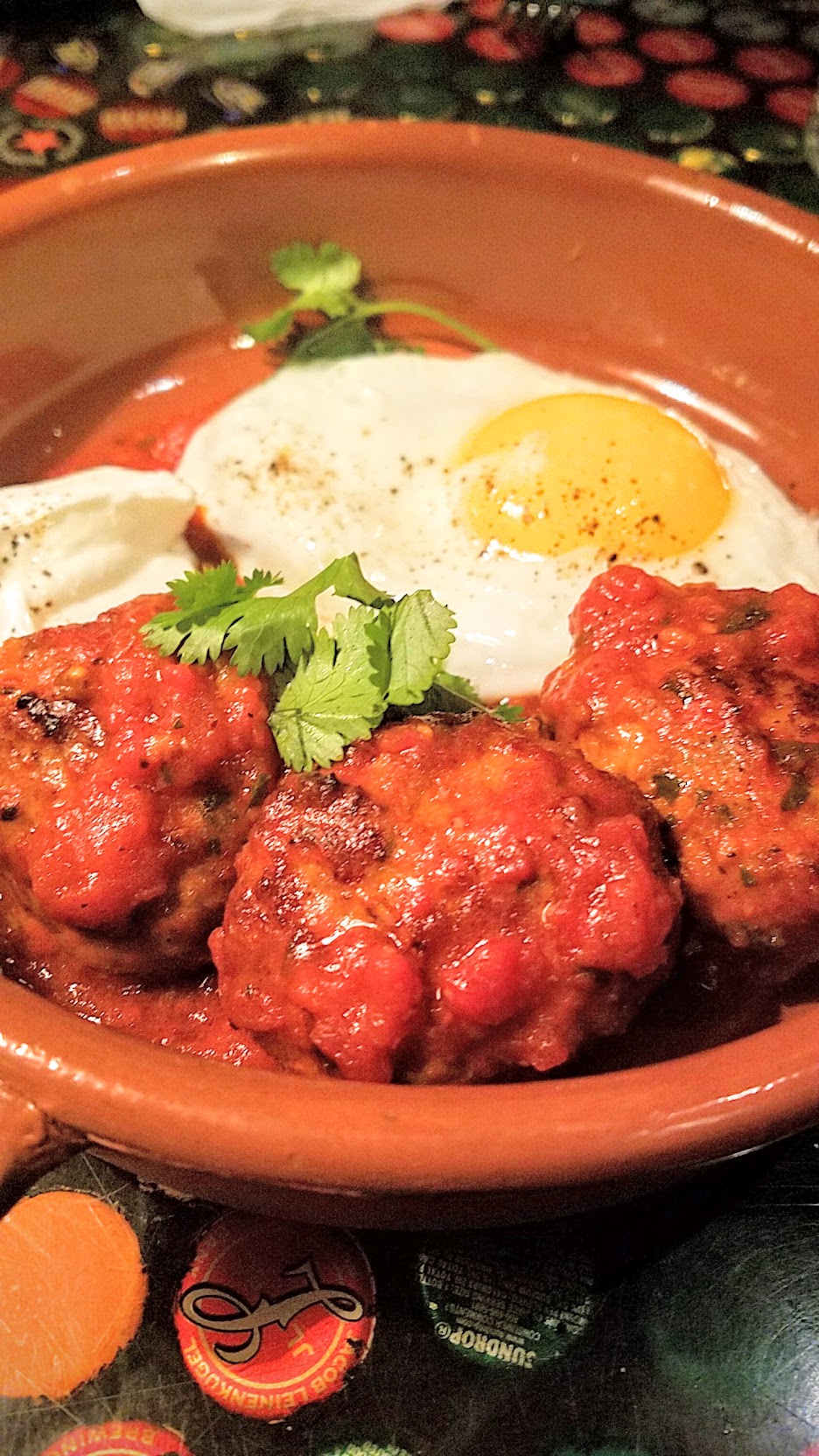 Example Food at Saraveza lamb meatballs with tomato sauce, yogurt, and sunny egg