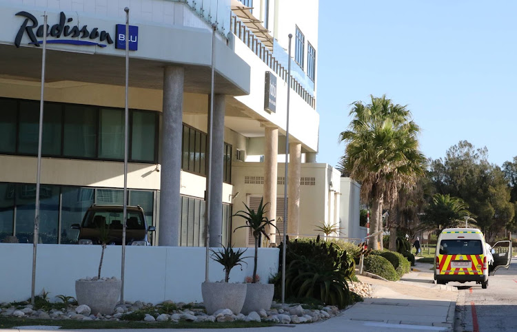 An emergency services transport vehicle is spotted outside the Radisson Blu in Port Elizabeth on Friday. The luxury beachfront hotel is being used as a quarantine facility for Covid-19 patients.