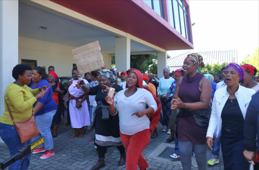 HAD ENOUGH: Parents from BCM protest outside the scholar transport headquarters in Vincent after they were apparently promised transportation for their children when schools opened on Tuesday this week Picture: SIBONGILE NGALWA